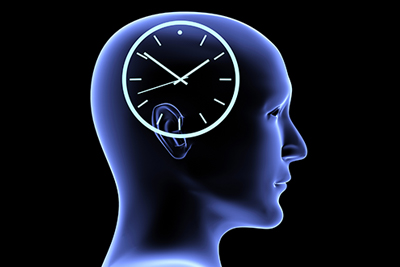 and blue neon side profile of a human head with a analog clock above the ears. 