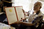 Joseph Murray holds his Nobel Prize certificate<br/>Photo by Bill Polo/The Boston Globe/Getty Images