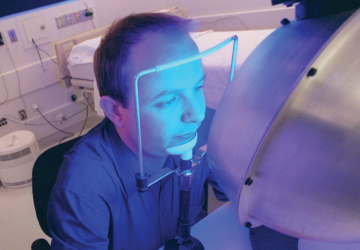 BLUE LIGHT SPECIAL: Steven Lockley, of the sleep medicine lab at Brigham and Women's Hospital, resets his circadian rhythm with blue light therapy. </br>Photo credit: Kris Snibbe/Harvard News Service