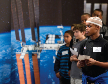 RAPT AND READY:  Schoolchildren at an event at the U.S. Department of Education in  Washington, D.C., wait for their chance to question astronauts. </br> Photo credit: Paul Alers/NASA