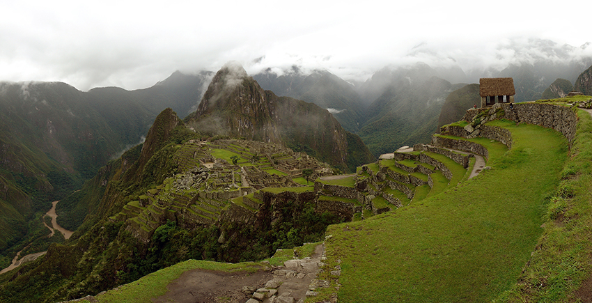 panorama of Machu Picchu site beneath cloudy sky