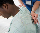 stethoscope on patient's back