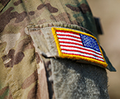 camo military uniform with upside down american flag