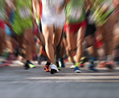 blurred image of runners' legs