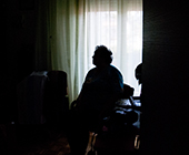 silhouette of elderly woman in room alone