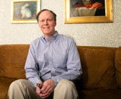 Photo of Kaelin on couch with art on wall