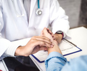 photo of doctor taking patient's pulse