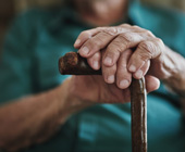 photo closeup of elderly man's hands on a cane
