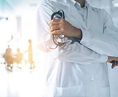 Shot of unidentified doc with a white coat 