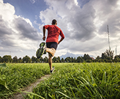 photo of man running on path away from camera