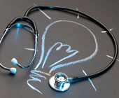 Stethoscope looped around a chalk drawing of a lightbulb