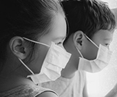 two children with medical masks on