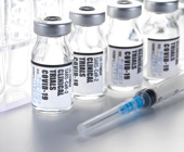 photo of syringe and vaccine vials with clinical trials COVID-19 printed on them
