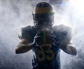 silhouette of a football player holding a ball
