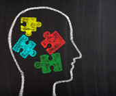 chalkboard illustration of a head with colorful puzzle pieces in it
