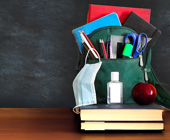 blackboard and books, school supplies and medical mask