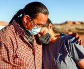 A husband and wife comfort one another during the Coronavirus shutdown on the Navajo nation in Arizona