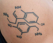 Tatoo of dopamine and serotonin on scientist's arm