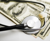 photo of stethoscope on top of money