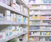photo of shelves stocked with prescription drugs at a pharmacy