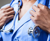 Image of a black physician in scrubs with stethoscope