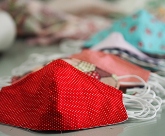 Several cloth face masks of different colors and patterns