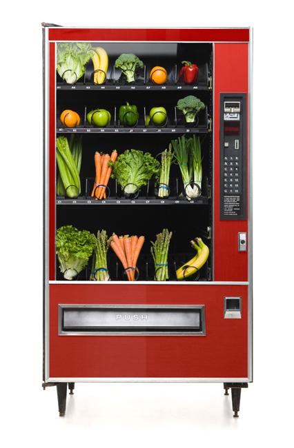full view of red vending machine filled with vegetables