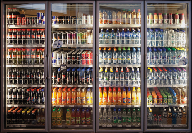 row of full-sized refrigeration units filled with soft drinks