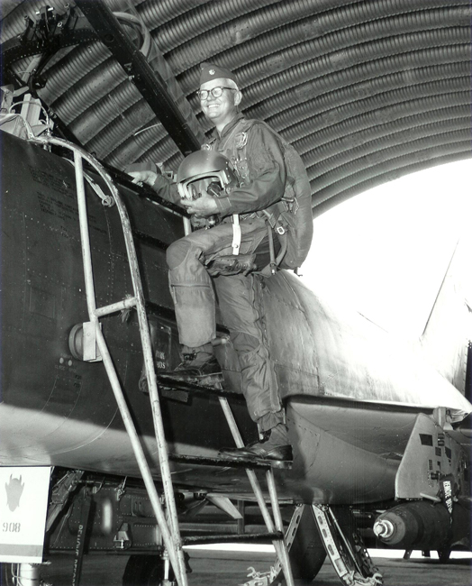 portrait of Royce Moser climbing into the cockpit of an airplane