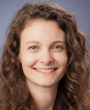 head shot of a smiling woman with wavy hair