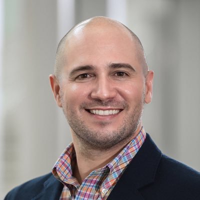Head shot of a smiling man with bald head