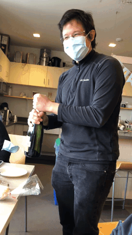 Looping video of Marco Jost opening a bottle of champagne in his lab