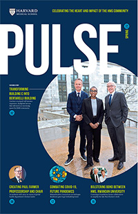 Cover the spring 2023 issue of Pulse. Large photo of three people standing on the HMS campus.