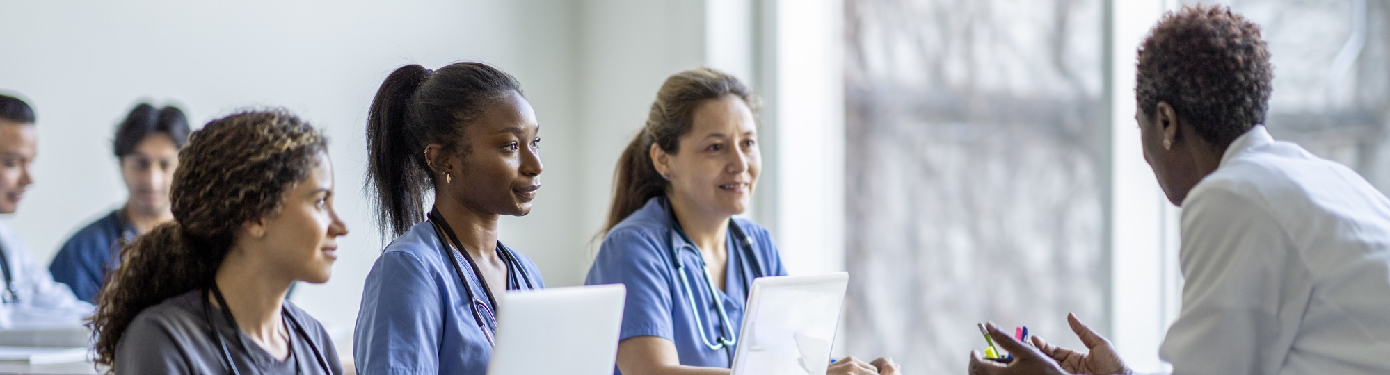 Students speaking to a doctor.