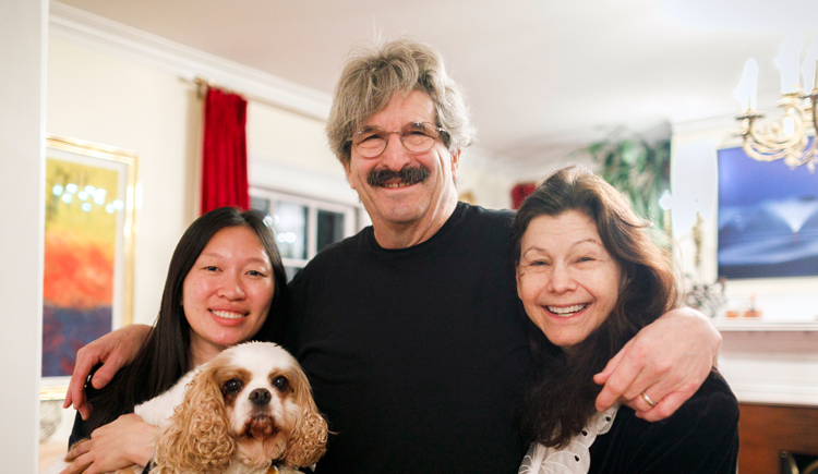 Gary Ruvkun with daughter Victoria Ruvkun (left), dog Barnaby, and wife Natasha Staller the morning of the announcement at their home in Newton.