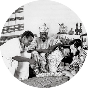 Stanley Bohrer (right) plays mancala with two Nigerian friends