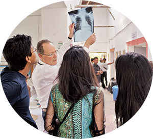 Paul Farmer examines an X-ray with the medical team at Bayalpata Hospital in Achham, Nepal, in 2012.  