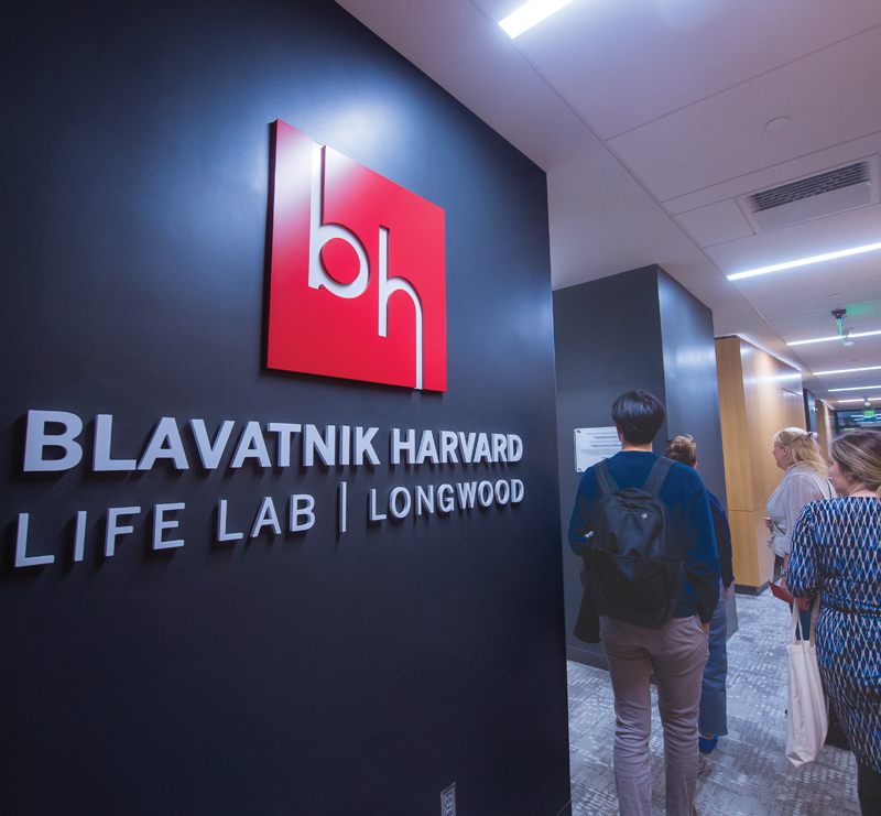 Entrance to the Blavatnik Harvard Life Lab | Longwood, with visitors walking through the corridor.