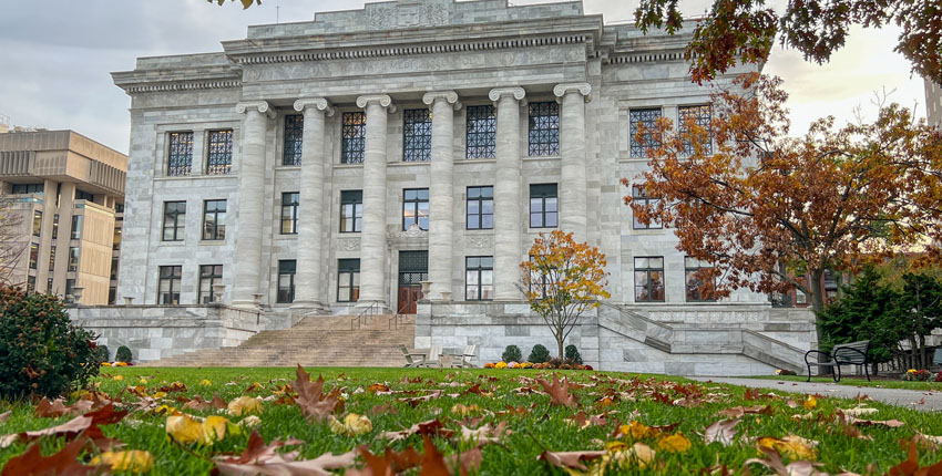 Front view of Gordon Hall surrounded by vibrant fall foliage.