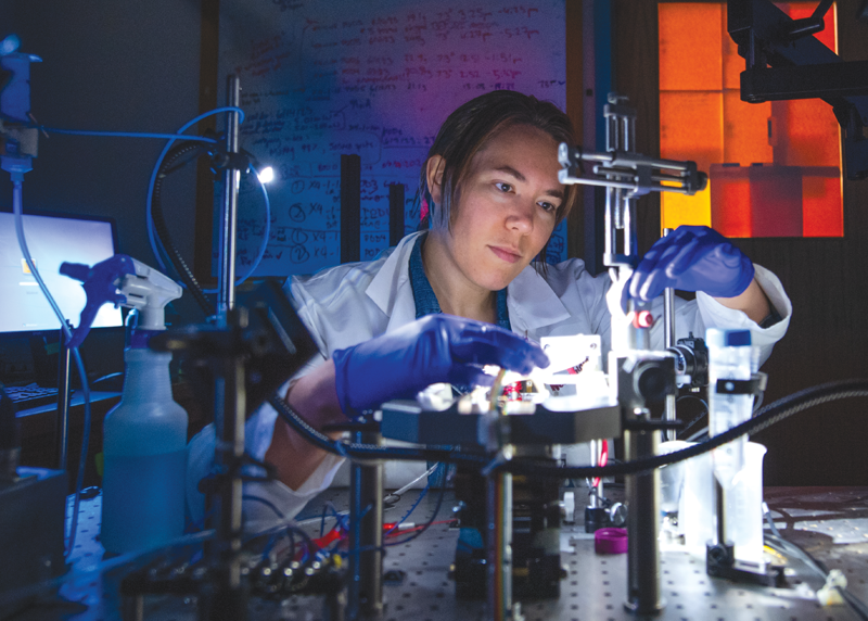 A researcher in a laboratory setting, conducting  experiments with advanced scientific equipment, highlighting innovation and dedication in the field of neurobiology.