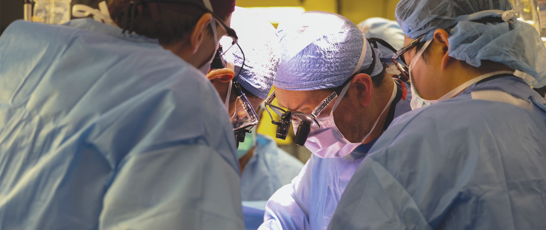 A team of surgeons in an operating room performing a procedure.