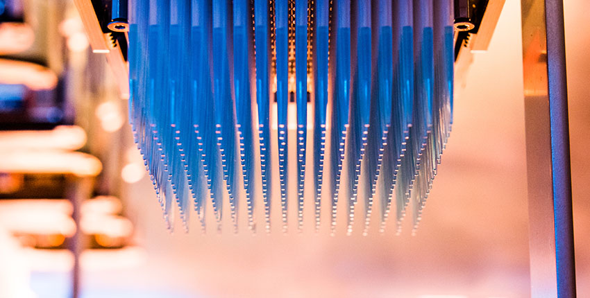 Narrow pipettes hanging upside down from a high-throughput screener