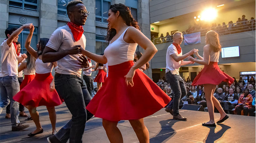 3 couples dancing on a stage