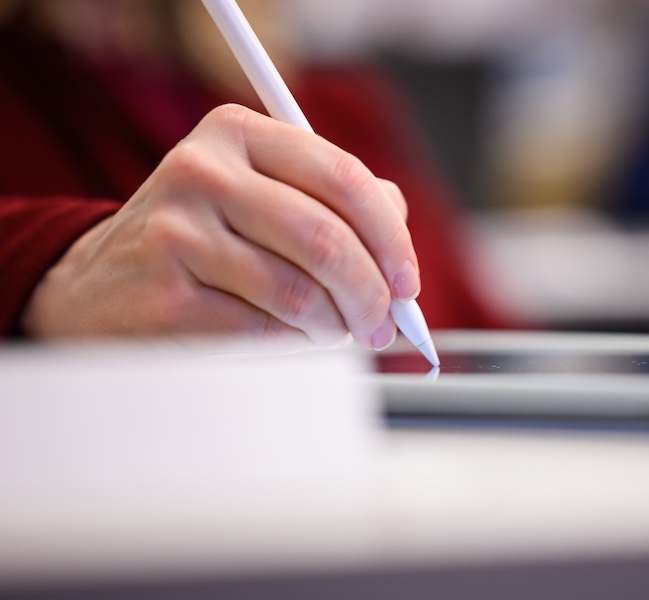 A hand writing on an iPad. Image: Gretchen Ertl