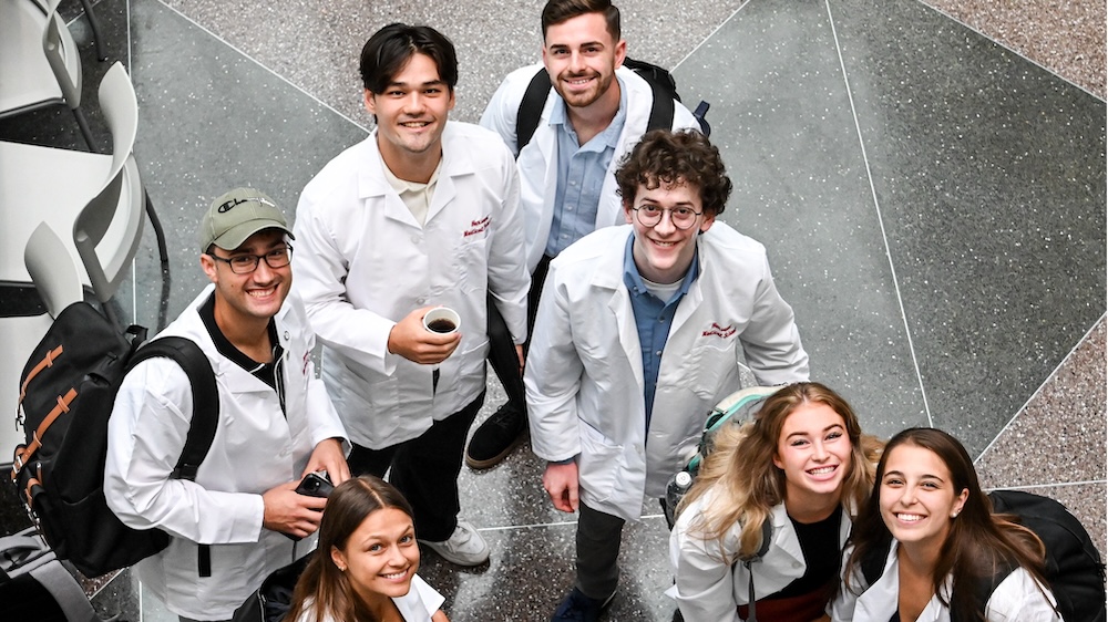 A group of students gather casually over coffee.