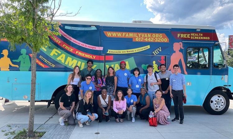 Family Van staff pose for a group picture outside the van.