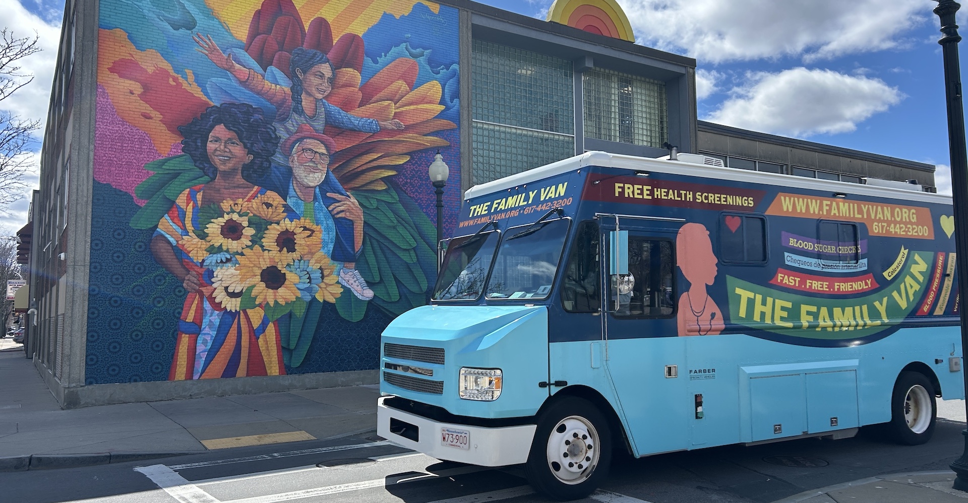 The family van in front of a colorful mural.