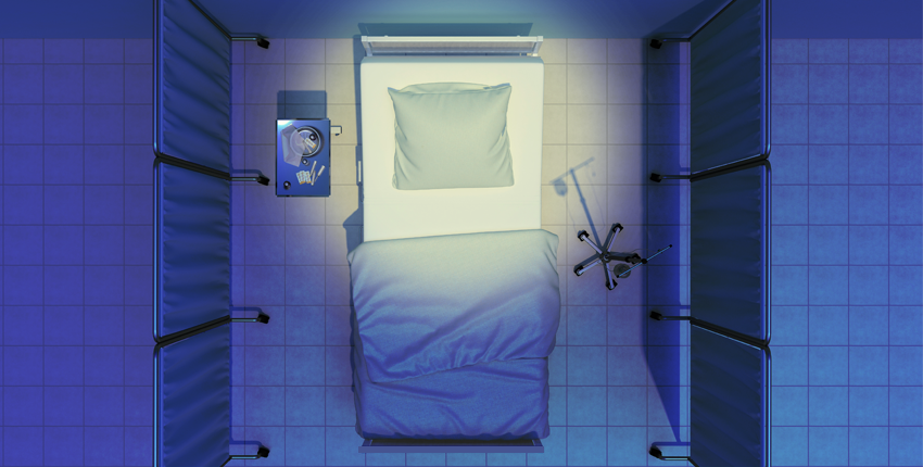 Overhead view of an empty hospital bed with blue sheets, surrounded by privacy screens, with an IV stand on one side and a small table with supplies on the other.