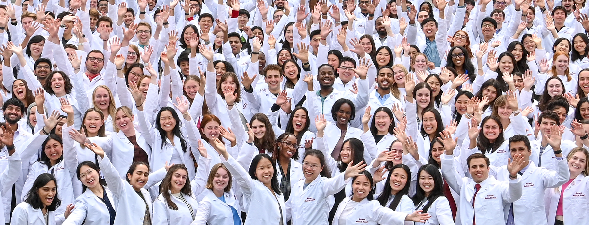 Students in white coats smiling
