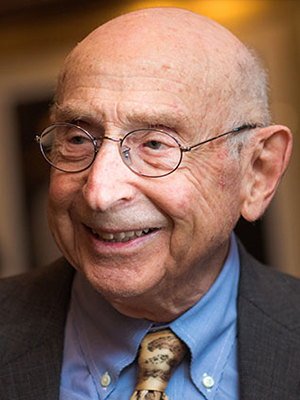 James Adelstein smiles while looking off to the side of the camera